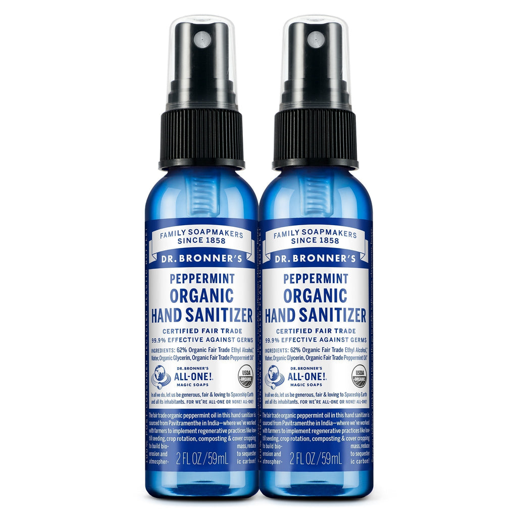 Two blue 2 fl oz bottles of Dr. Bronners Peppermint Organic Hand Sanitizer with spray tops, labeled as certified fair trade. Text reads FAMILY SOAPMAKERS SINCE 1858, PEPPERMINT ORGANIC HAND SANITIZER, CERTIFIED FAIR TRADE, and ALL ONE Ideal for eco friendly hygiene