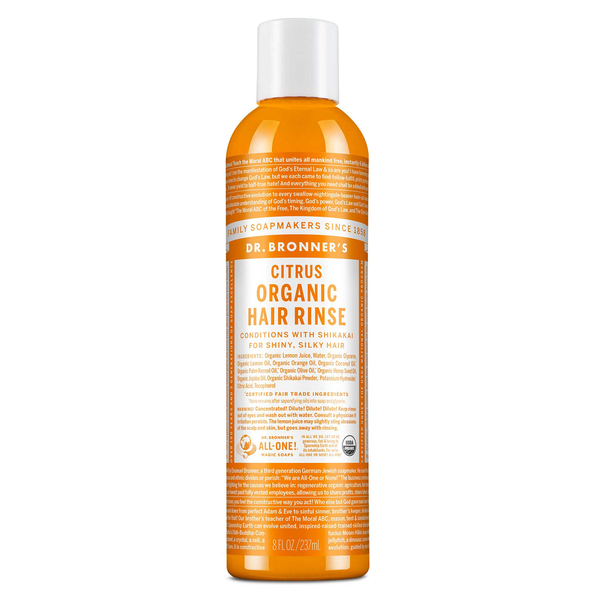 A bottle of Dr. Bronners Citrus Organic Hair Rinse stands upright. The orange bottle features detailed text about its conditioning benefits with shikakai for shiny, silky hair. Label promotes fair trade and organic certification [8 oz]